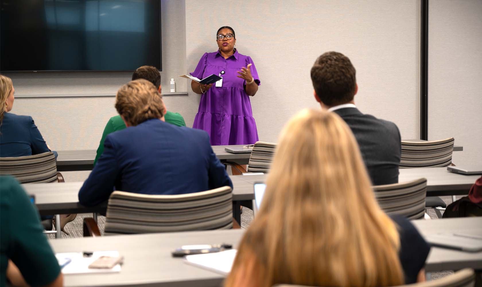 A Dismore team member presents on a meeting